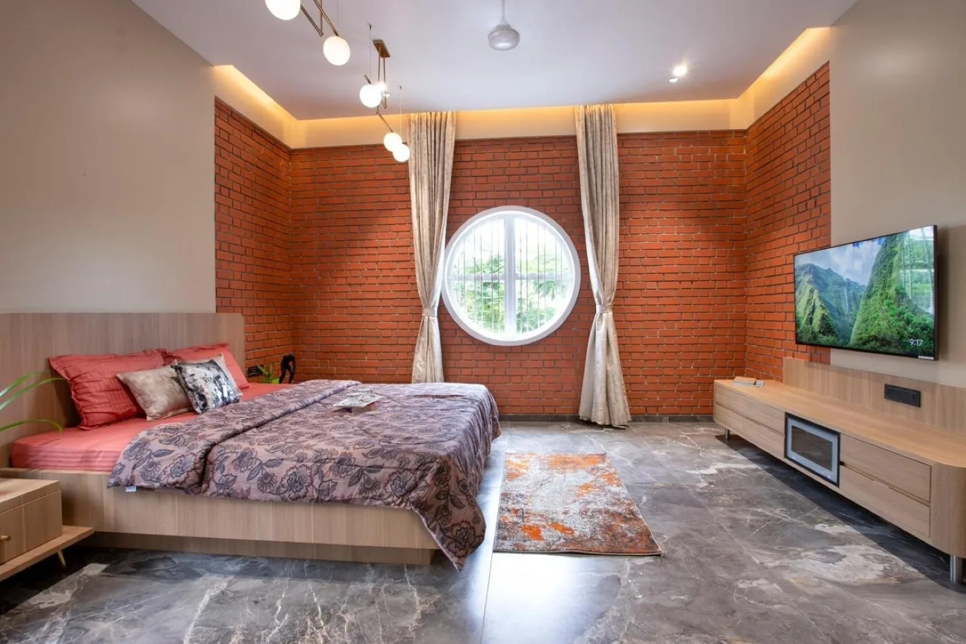 Modern bedroom featuring exposed architectural brick walls and contemporary interior design in Chennai.